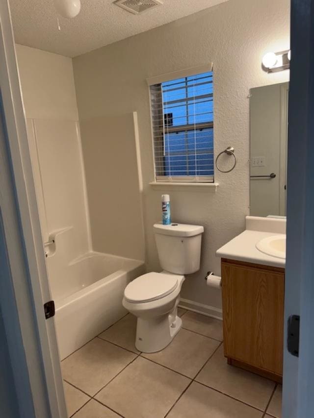 full bathroom featuring bathtub / shower combination, vanity, a textured ceiling, tile patterned flooring, and toilet