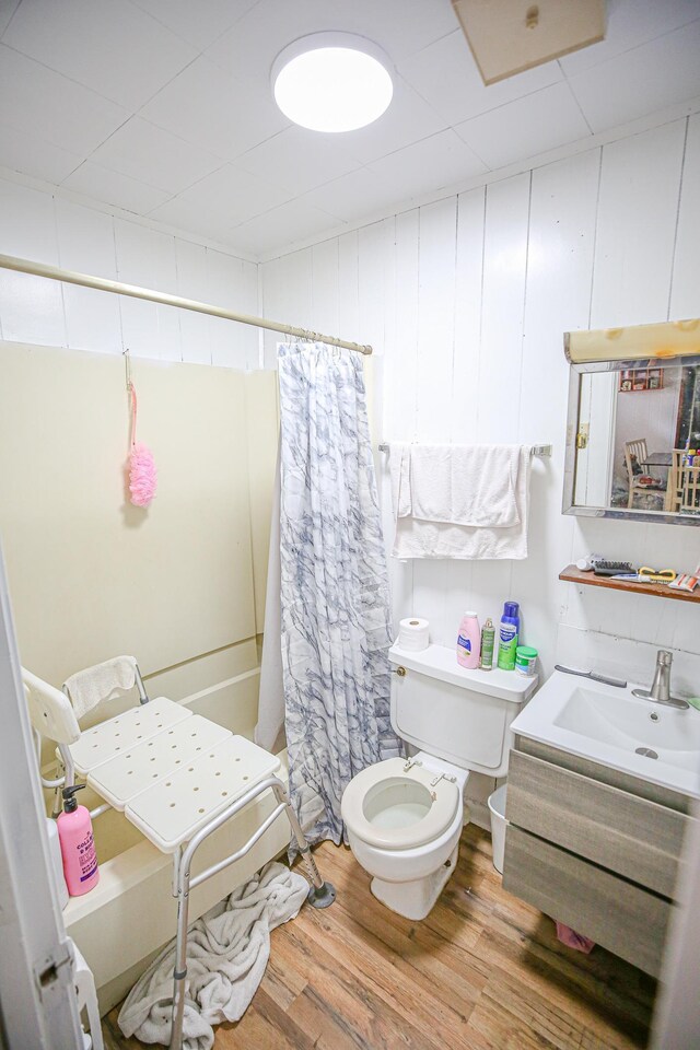 1315 S Center St Unit 1, Perry, FL 32348 - bathroom with wood finished floors, vanity, and a shower with shower curtain