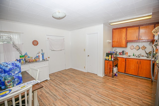 1315 S Center St Unit 1, Perry, FL 32348 - kitchen featuring brown cabinets, light wood-style flooring, and light countertops