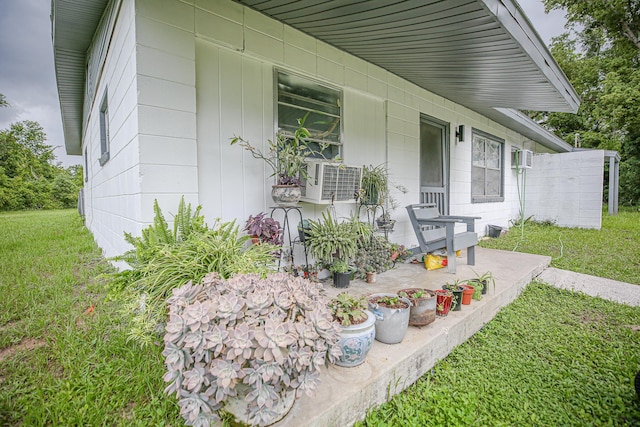 1315 S Center St Unit 1, Perry, FL 32348 - view of exterior entry with a lawn and cooling unit