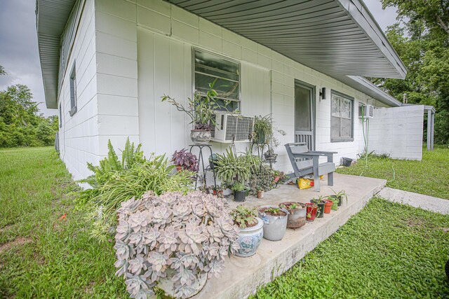1315 S Center St Unit 1, Perry, FL 32348 - view of exterior entry with a lawn and cooling unit