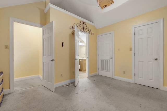 924 S Lipona Rd, Tallahassee, FL 32304 - unfurnished bedroom with carpet floors, vaulted ceiling, and ensuite bath