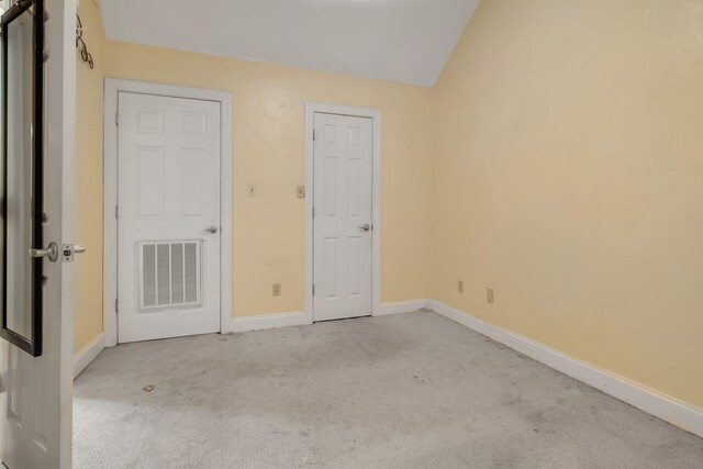 924 S Lipona Rd, Tallahassee, FL 32304 - unfurnished bedroom featuring carpet flooring and vaulted ceiling
