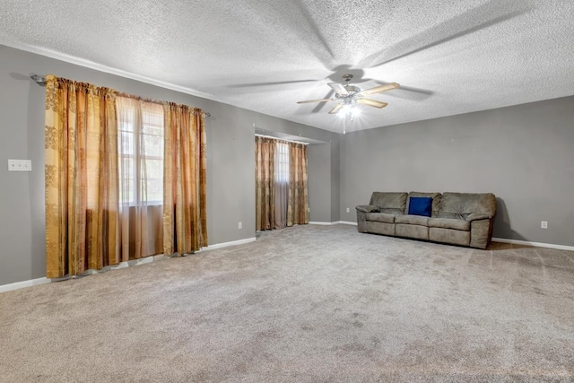 820 Essex Dr, Tallahassee, FL 32304 - unfurnished living room featuring healthy amount of natural light, ceiling fan, a textured ceiling, and carpet flooring