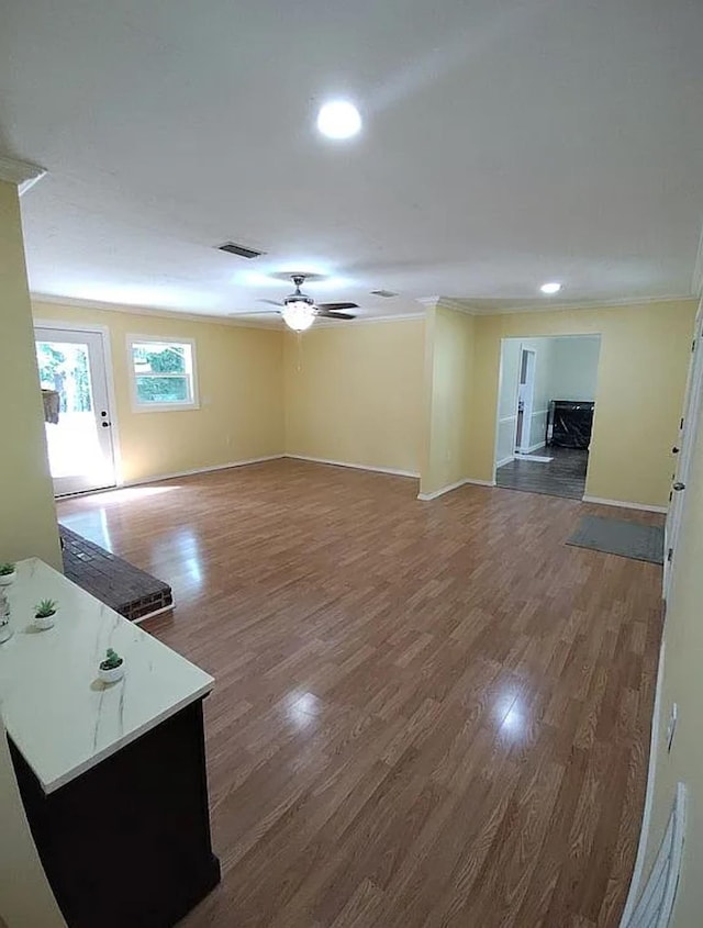 living room featuring dark wood-style floors, baseboards, and a ceiling fan