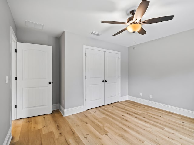 unfurnished bedroom featuring a closet, ceiling fan, and light wood-type flooring