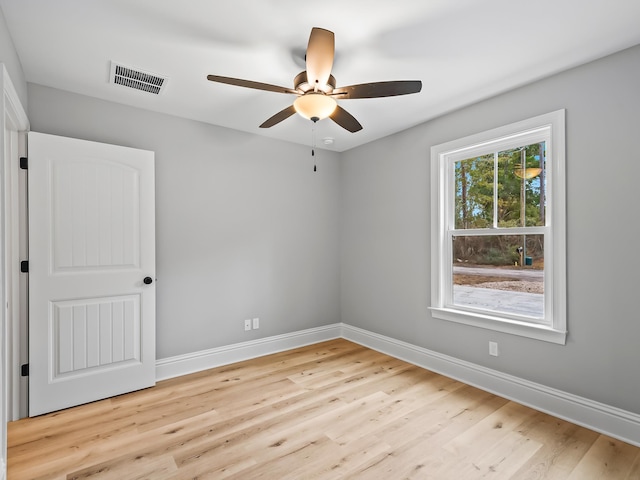 unfurnished room with ceiling fan and light wood-type flooring