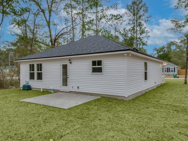 rear view of property with a yard and a patio