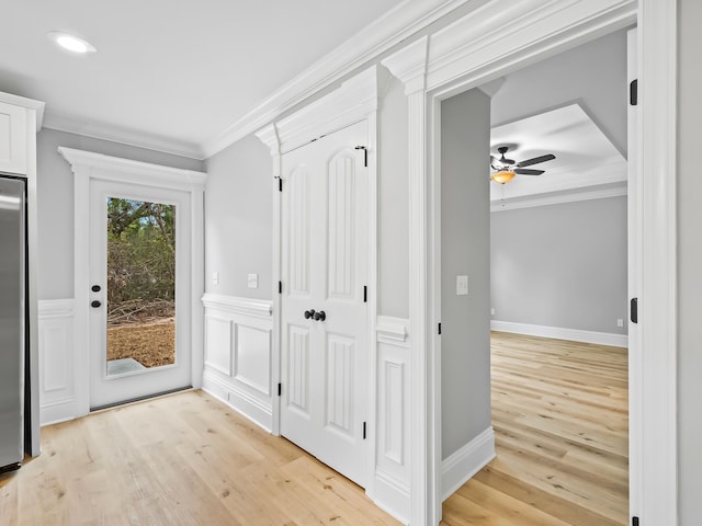 interior space featuring crown molding and light hardwood / wood-style flooring