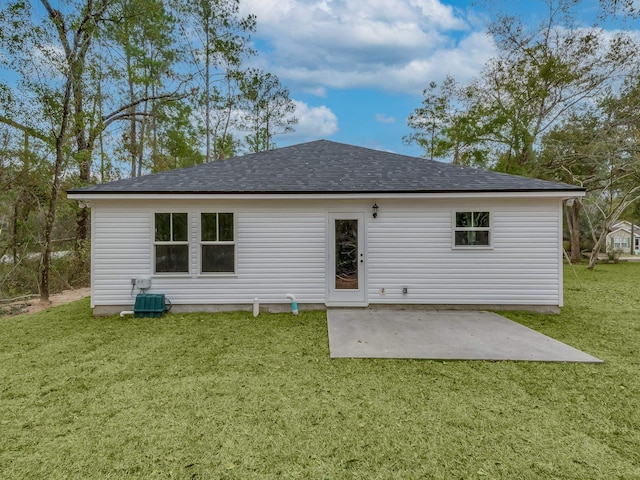 back of property featuring a patio, a yard, and central AC