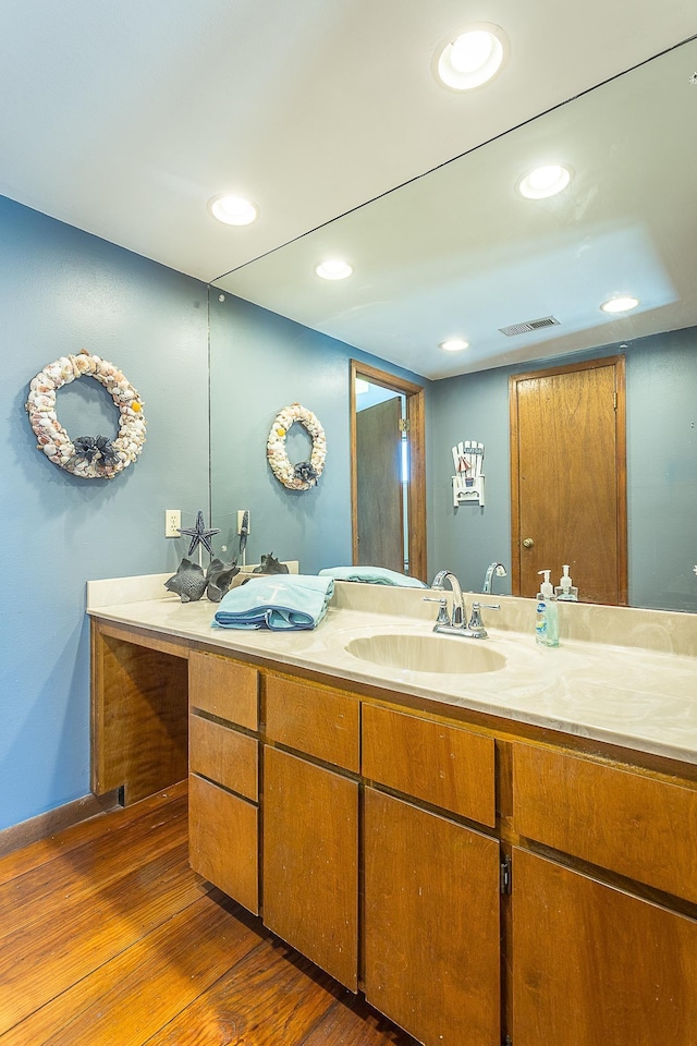 126 Royster Dr, Crawfordville, FL 32327 - bathroom with double vanity, wood finished floors, recessed lighting, and baseboards