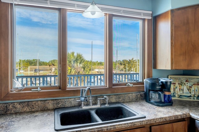 126 Royster Dr, Crawfordville, FL 32327 - kitchen featuring a sink and brown cabinetry