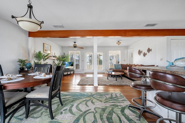 126 Royster Dr, Crawfordville, FL 32327 - living room featuring wood finished floors, beamed ceiling, a ceiling fan, and wooden walls