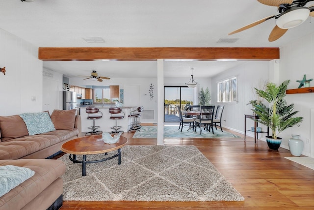126 Royster Dr, Crawfordville, FL 32327 - living area featuring a ceiling fan, beam ceiling, light wood-type flooring, and baseboards