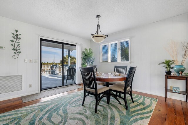 126 Royster Dr, Crawfordville, FL 32327 - dining area featuring wood finished floors, baseboards, and a textured ceiling