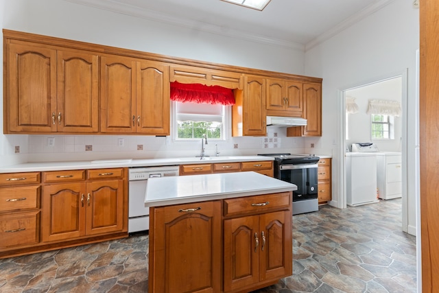 186 NW Whispering Pines Loop, Madison, FL 32340 - kitchen featuring plenty of natural light, under cabinet range hood, dishwasher, washer and dryer, and stainless steel electric range