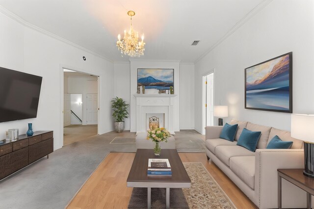 186 NW Whispering Pines Loop, Madison, FL 32340 - living room featuring a fireplace, visible vents, an inviting chandelier, and crown molding