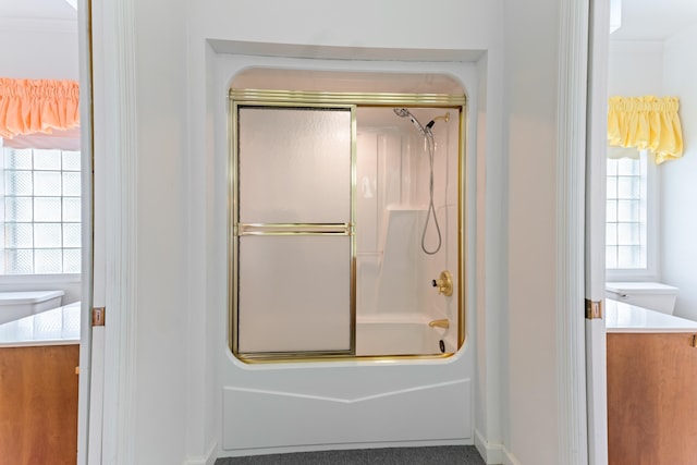 186 NW Whispering Pines Loop, Madison, FL 32340 - bathroom with baseboards, bath / shower combo with glass door, and vanity