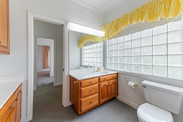 186 NW Whispering Pines Loop, Madison, FL 32340 - bathroom with toilet, vanity, carpet, crown molding, and baseboards