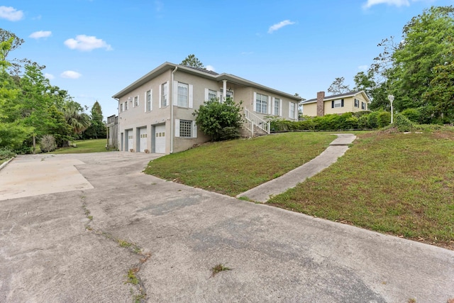186 NW Whispering Pines Loop, Madison, FL 32340 - view of side of property featuring an attached garage, a yard, and driveway