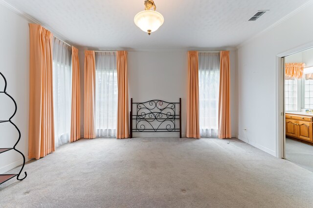 186 NW Whispering Pines Loop, Madison, FL 32340 - spare room featuring light colored carpet, crown molding, and visible vents