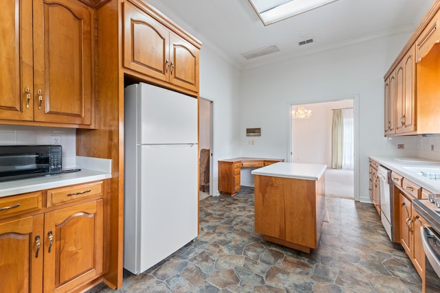 186 NW Whispering Pines Loop, Madison, FL 32340 - kitchen with white appliances, stone finish flooring, visible vents, crown molding, and tasteful backsplash