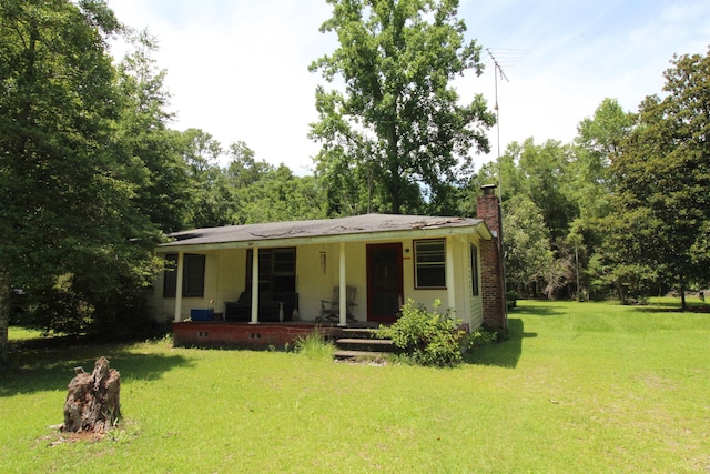 30 Ace High Ln, Crawfordville, FL 32327 - bungalow-style house featuring a front lawn, a chimney, and a porch