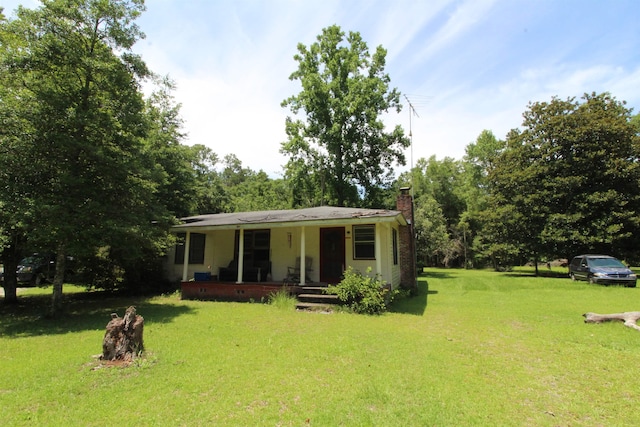 30 Ace High Ln, Crawfordville, FL 32327 - view of front facade with a porch, a front yard, and a chimney