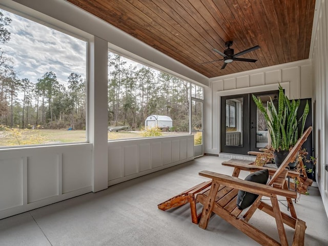 sunroom featuring ceiling fan, wood ceiling, and a healthy amount of sunlight