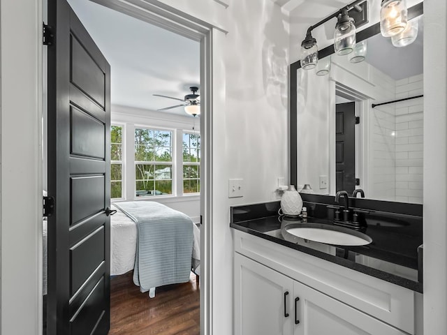 bathroom with hardwood / wood-style floors, ceiling fan, and vanity