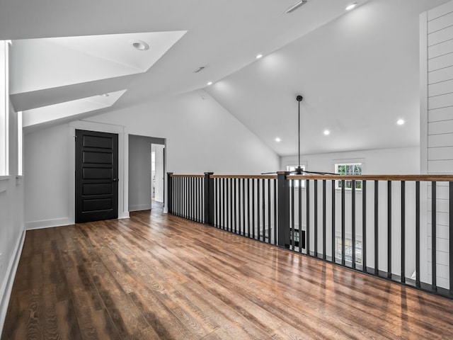 empty room with hardwood / wood-style flooring, high vaulted ceiling, and ceiling fan