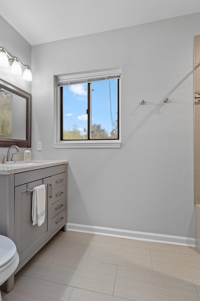 bathroom featuring tile patterned flooring, vanity, and toilet