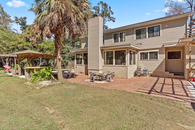 rear view of house with a yard and a patio area