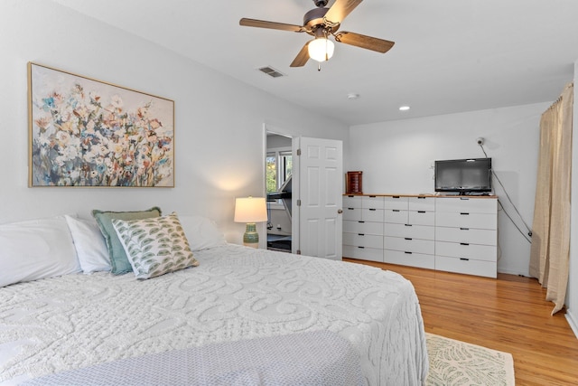 bedroom with light hardwood / wood-style floors and ceiling fan