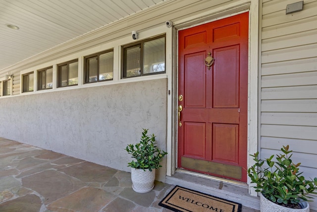 view of exterior entry featuring a porch