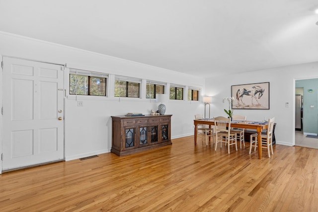 dining space with light wood-type flooring