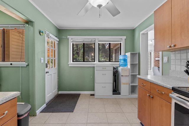 kitchen with light tile patterned flooring, backsplash, and ornamental molding