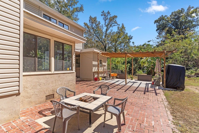 view of patio featuring a pergola and an outdoor fire pit