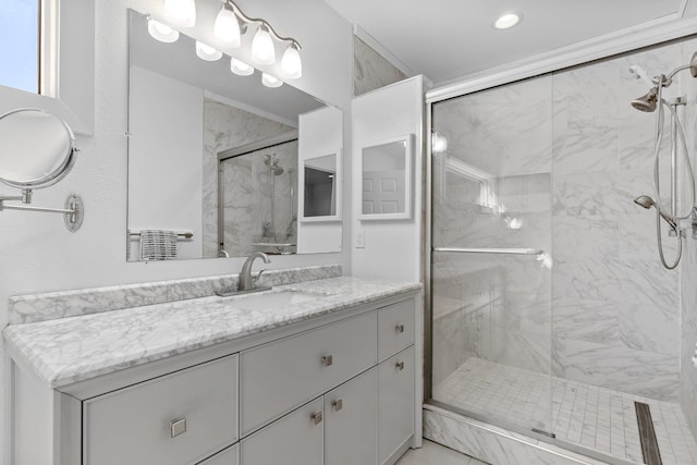 bathroom featuring an enclosed shower and vanity