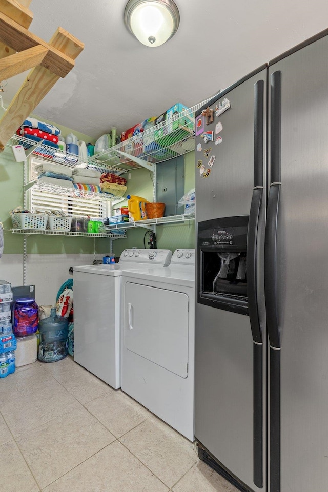 washroom with washing machine and dryer and light tile patterned floors