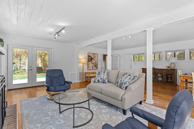 living room featuring french doors, light hardwood / wood-style flooring, wood ceiling, and track lighting