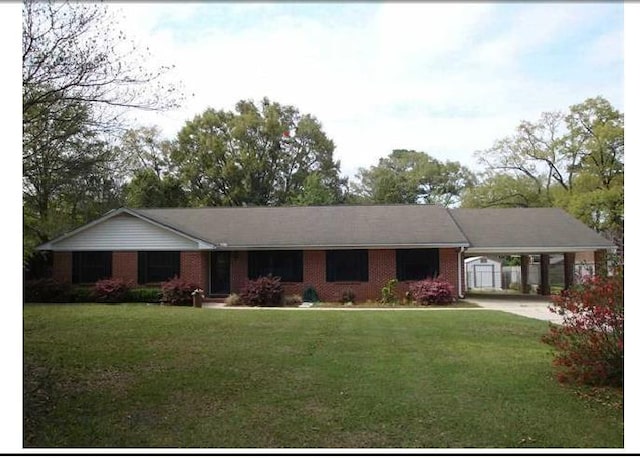 4034 Mcleod Dr, Tallahassee, FL 32303 - single story home featuring a carport, brick siding, a front yard, and concrete driveway