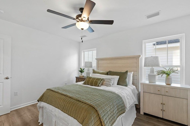 bedroom with ceiling fan and dark hardwood / wood-style floors