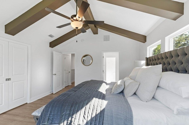 bedroom with lofted ceiling with beams, light wood-type flooring, and ceiling fan