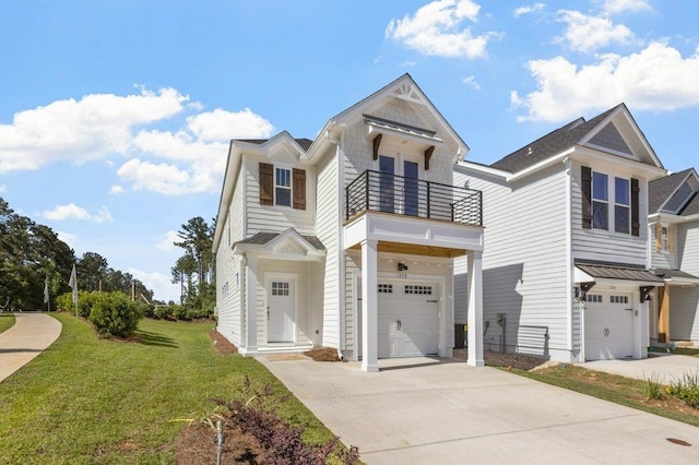 view of front facade featuring a balcony, a garage, and a front yard