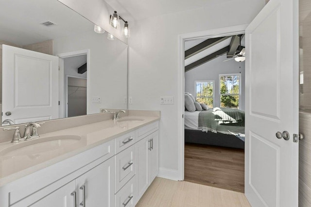 bathroom featuring ceiling fan, vanity, hardwood / wood-style floors, and vaulted ceiling with beams