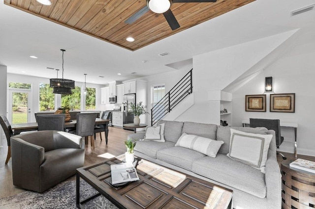 living room with wood ceiling, wood-type flooring, vaulted ceiling, and ceiling fan