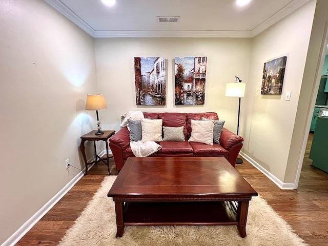 2401 Mexia Ave, Tallahassee, FL 32304 - living area with crown molding, baseboards, wood finished floors, and recessed lighting