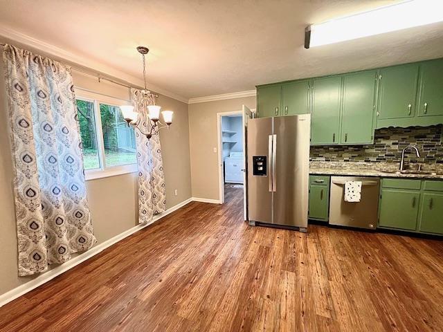 2401 Mexia Ave, Tallahassee, FL 32304 - kitchen featuring appliances with stainless steel finishes, green cabinetry, a sink, dark wood finished floors, and ornamental molding