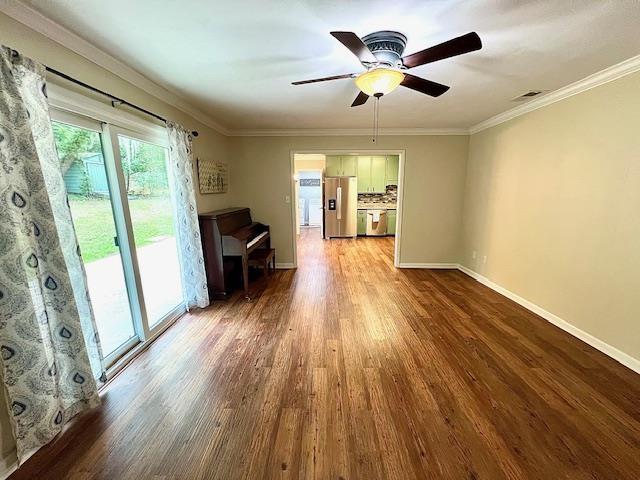 2401 Mexia Ave, Tallahassee, FL 32304 - unfurnished living room with wood finished floors, a ceiling fan, crown molding, and baseboards